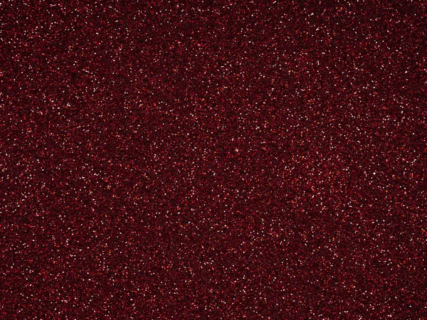Dark Red glitter. Perfect holographic background or pattern of sparkling shiny glitter for decoration and design of Christmas, New Year, Valentine Day, xmas gift card or other holiday pictures.