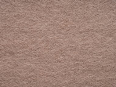 Natural dark beige or soft brown felt, velvet texture. Soft background for text, lettering, patchwork or other art work. Full frame backdrop pattern wallpaper of art and stationery material
