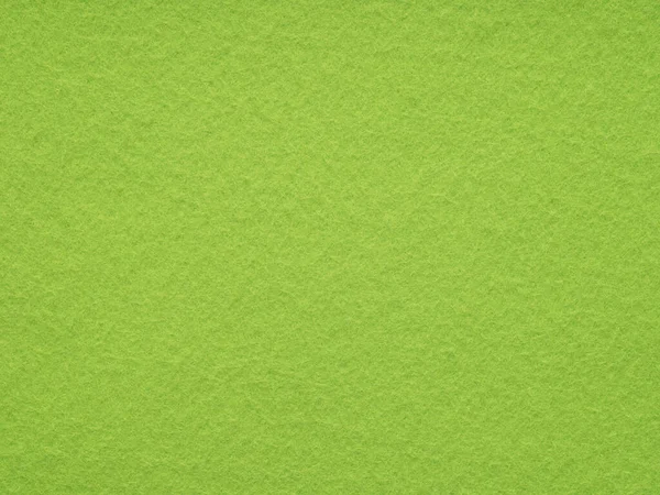 Texture of lime or bright green felt close-up, close-up. Handicraft concept, crafts, DIY, do it yourself. Top view, flat lay, layout, place for text. For shops with goods for creativity, patchwork