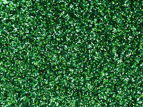 Dark green glitter. Perfect holographic background or pattern of sparkling shiny glitter for decoration and design of Christmas, New Year, Patrick Day, xmas gift card, 3d or other holiday pictures