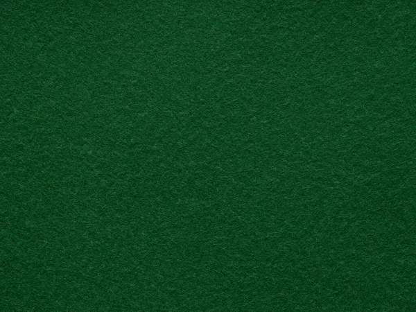 Dark green felt background texture. Surface of snooker or poker table. Natural felt for patchwork or other artwork. Full frame background texture pattern of art, stationery material in contrast color