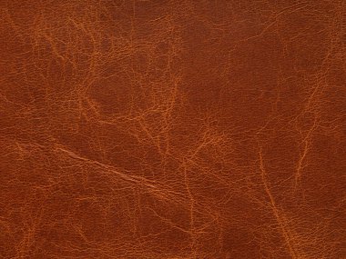 Genuine luxury orange, red, brown leather texture sample. Background with copy space. Faux eco leather. Textured backdrop effect for design, upholstered furniture. Pattern with place for text