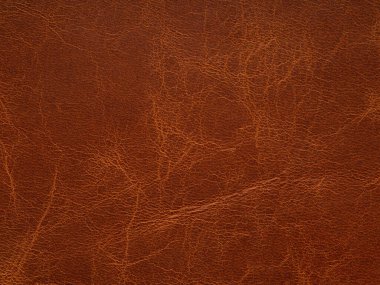 Genuine brown leather. Natural material with design lines. Pattern or abstract background. Genuine leather texture. Use wallpaper or backdrop luxury event, design upholstered furniture, clothing