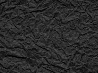 Black dark matte crumpled paper texture. Background for handcrafts, new year designs decoration, text, lettering, wall screen saver. Vintage material, sheet or page for decoration art.