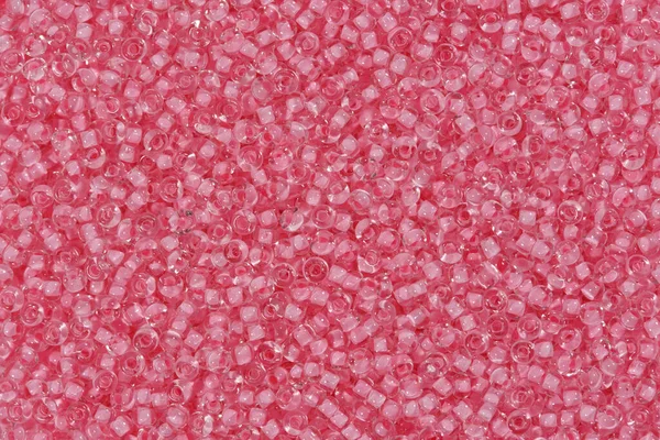 Light pink glass beads. Texture. Close up shot.