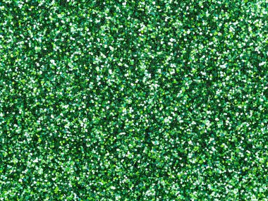 Dark green glitter. Perfect holographic background or pattern of sparkling shiny glitter for decoration and design of Christmas, New Year, Patrick Day, xmas gift card, 3d or other holiday pictures.