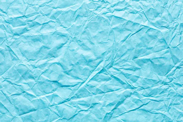 Yeni tebrik kartınızın bir parçası olarak zarif mavi renkte buruşmuş kağıt dokusu, yeni bayram arkaplanı.