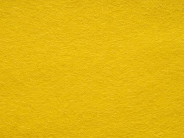 Canlı bir kanarya sarısı keçeli yüzey, ışıl ışıl ve neşe dolu, mutluluk ve hayal gücü ile dolu, görsel olarak canlandırıcı bir doku sunar.