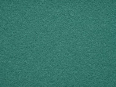Görüntü, sükuneti ve minimalist estetiği çağrıştıran zengin bir dokuyla rahatlatıcı bir keçe yüzeyi sergiliyor.