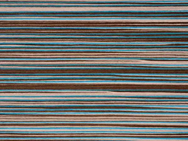 Tasarımda cesur bir ifade, bu kaplamalı yüzey canlı deniz mavisi şeritleri içeriyor, zengin kahverengi bir zemin üzerinde, renkli görsel bir senfoni sunuyor.