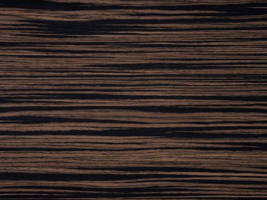 Bu kaplama yüzeyi, koyu, siyah doğrusal desenlerle çelişen koyu çikolata tonlarına sahip abanoz ağacının doğal lüksünü sergiliyor. Cilalı bitirişi, ormanın kaliteli ve zamansız cazibesini vurguluyor