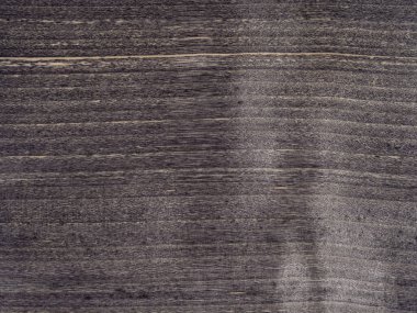 Yakından bakınca karanlık harborica ahşap yüzeyinin karmaşık tanecikleri ve desenleri ortaya çıkıyor.