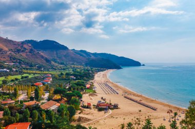 Beach and sea landscape with Sperlonga, Lazio, Italy. Scenic resort town village with nice sand beach and clear blue water in picturesque bay. Famous tourist destination in Riviera de Ulisse clipart