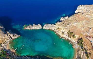 Hava kuşları göz görünümü drone fotoğraf Saint Paul koyun köy Lindos yakın, Rodos adası, Oniki, Yunanistan. Lagün ve berrak mavi su ile güneşli panorama. Güney Avrupa'nın ünlü turistik beldesi