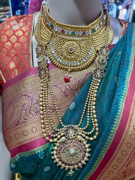 A woman wearing traditional sari with belly chain jewellery known as in a fashion store