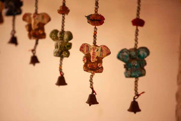 Warm indoor scene with handcrafted Mexican dolls hanging and embellished with cultural motifs