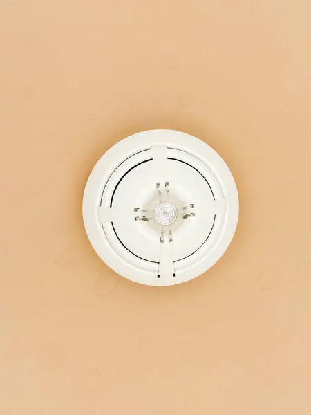 Ceiling fire detector. Fire alarm on the ceiling. A smoke detector fire alarm. Closeup smoke detector on a ceiling