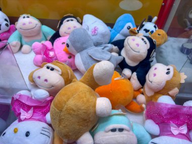 Bir grup doldurulmuş hayvan, Hello Kitty, bir maymun, bir kedi, bir köpek, bir kuş, bir balık ve bir inek de dahil olmak üzere bir vitrinde.