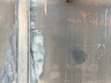 Kirli, yıpranmış, üzerinde grafiti olan bir duvar. Grafiti diyor ki: 