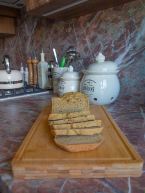 New stylish kitchen environment with baked bread. Kitchen counter, with bread, spice and other dishes.