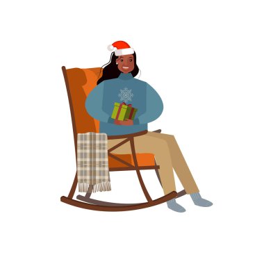 Noel Baba şapkalı mutlu kadınlar hediyeyle birlikte sandalyede otururlar. Tasarımınız için Noel ögesi.