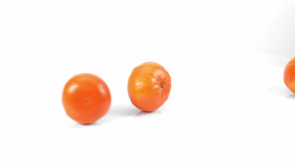 白い背景にオレンジの実を転がし 白いスローモーションに柑橘類 白い背景に新鮮なオレンジが動く — ストック動画