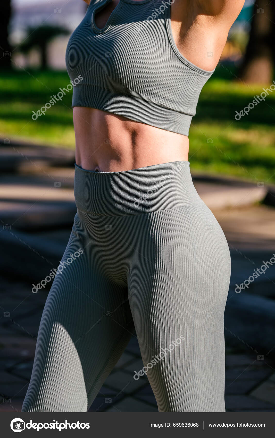 Woman in Red Sports Bra and Black Leggings Stretching · Free Stock Photo