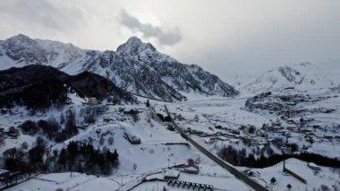 İnsansız hava aracı görüntüleri. Dağ vadisi. Gürcistan 'ın Kazbegi vadisinde karla kaplı dağlar. 
