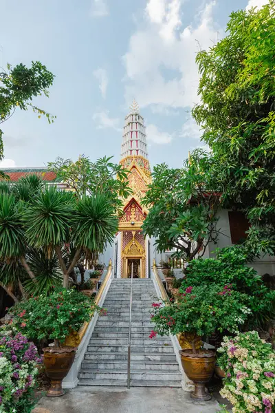 stock image Front view of Wat Chakkrawat Rachawat Woramahawihan Wat Sam Pluem, surrounded by blooming trees, Bangkok, Thailand