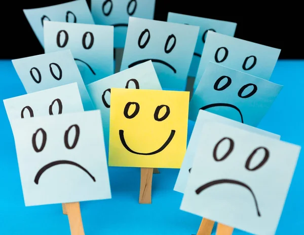 Sticky notes with hand drawn Smiley face and Sad faces. Positive way of thinking concept. Positive mind overcomes negative
