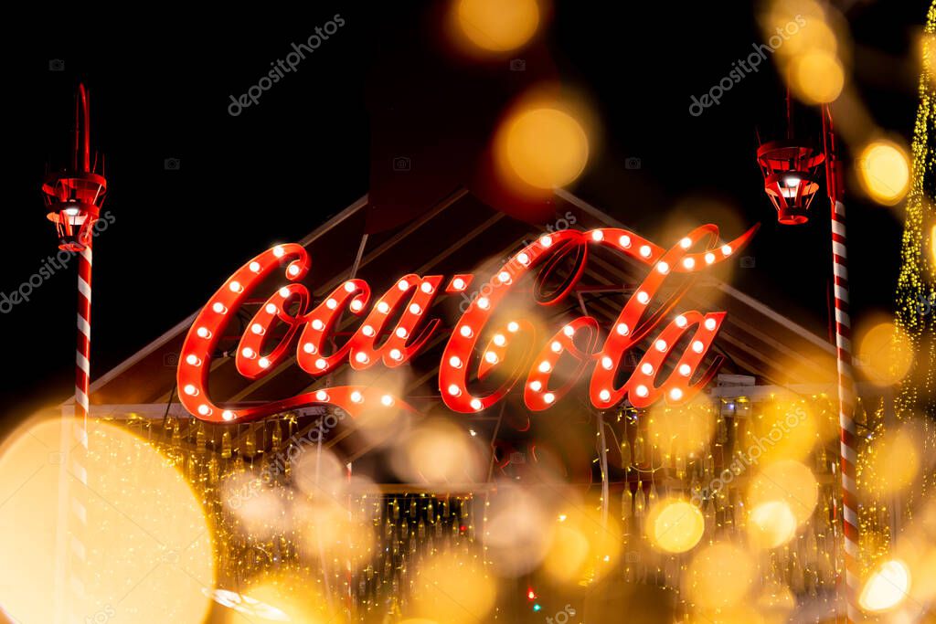 Belgrade, Serbia - December 23, 2022: Coca Cola logo at exhibition stand in the streets of Belgrade on Christmas holidays in the night