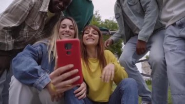 Dışarıdaki bir grup öğrenci cep telefonuna bakıyor. Neşeli bir kız arkadaşlarına selfie çekmelerini söyler. Sosyal ağlarla birbirine bağlı üniversite sınıf arkadaşları.