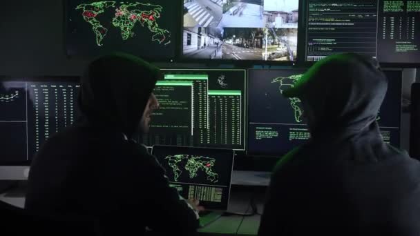 Two Hooded Criminal Hacker Using Computer Organizing Global Massive Data — Vídeo de Stock