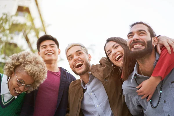 Three couples having fun piggybacking at sundown. High quality photo