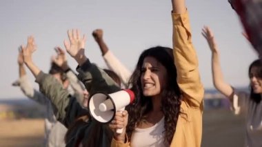 Woman Shouting on Megaphone in a Public Demonstration on the Street. Group of Multiethnic People making Protest. High quality FullHD footage