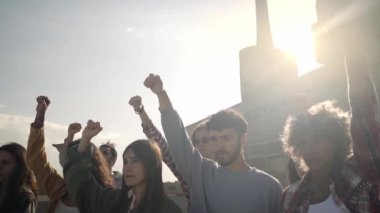 Slow motion of a group of activists protesting outdoors in the city. People demonstration for the rights. High quality FullHD footage