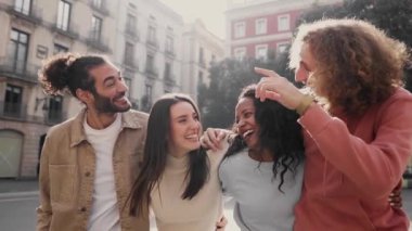 Cheerful happy friends laughing while walking in the street of a city. People having fun sharing free time. High quality FullHD footage