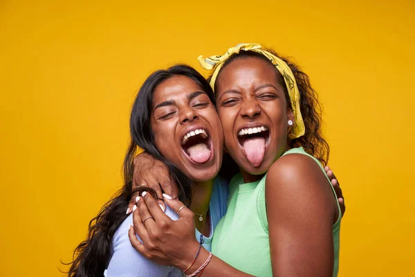 Two Diversity Pretty Positive Girls Stick Out Your Tongue Hugging — Stock Photo, Image