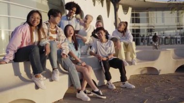 Happy group of students having fun together. Young people outdoors at university campus and education concept. High quality photo