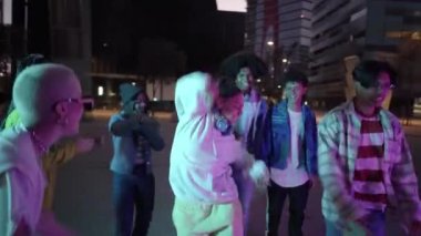 Dancing young people breakdancing in street hip hop dancer practicing dance routine performing freestyle moves in city at night. High quality 4k footage