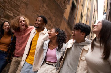 Group of twenties people walking in the street and. having fun together. High quality photo