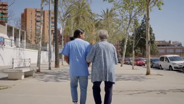 할머니는 이웃에 가정의 도움을 받으며 다닌다 노인들을 야외에서 봉사를 소녀가 — 비디오