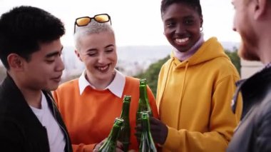 Friends drinking beer at terrace outdoors on weekend. Friendship concept with young people having fun together toasting brew pint on happy hour at pub. High quality photo