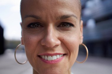 Kameraya bakan orta yaşlı beyaz kadın portresi. Açık havada gülümseyen neşeli Avrupalı kadın yüzünü kapat. Olumlu ifadeli mutlu, tıraşlı, beyaz bir insan. Kırklı yaşlardaki insanlar.. 