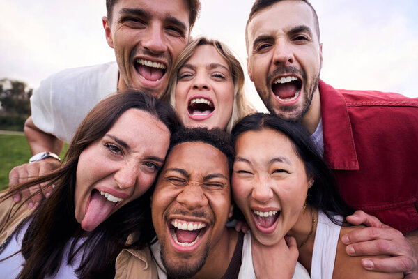 Portrait multiracial friends excited outdoors. Group of diverse young people with funny expression posing together for selfie photo. Happy people enjoying friendship in community. Social relationships