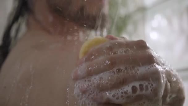 코카서스 남자는 어깨에서 얼굴에 샤워에서 휴식을 그녀의 스폰지를 청소합니다 위생을 — 비디오