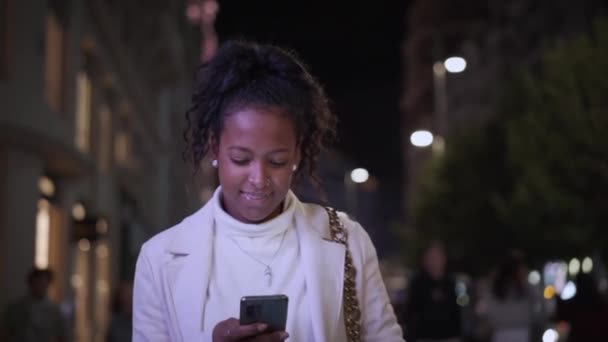 Młoda Latynoska Spaceruje Szczęśliwie Centrum Miasta Zimową Noc Korzystając Telefonu — Wideo stockowe