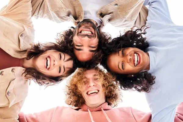 Team of happy young people looking at the camera embracing and having a fun. Smiling cheerful friends. High quality photo