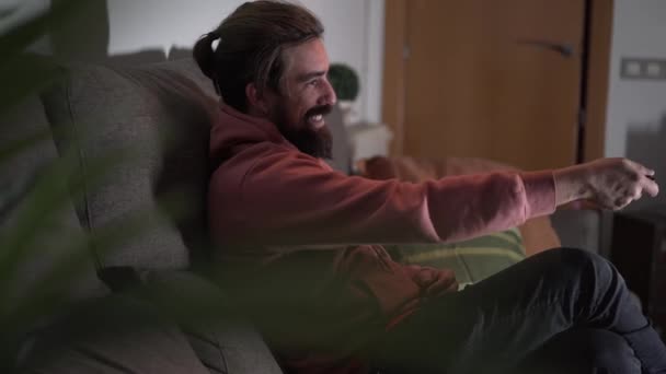 Side View Cheerful Bearded Caucasian Man Sitting Happy Sofa Laughing — Stock Video