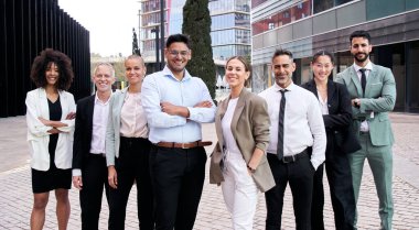 Takım portresi, çeşitli profesyonel güven pozu veriyor. Genç ve olgun meslektaşlar dışarıda kollarını kavuştururken kameraya gülümsüyor. Grup başarılı ofis çalışanları resmi giysiler içinde duruyorlar.